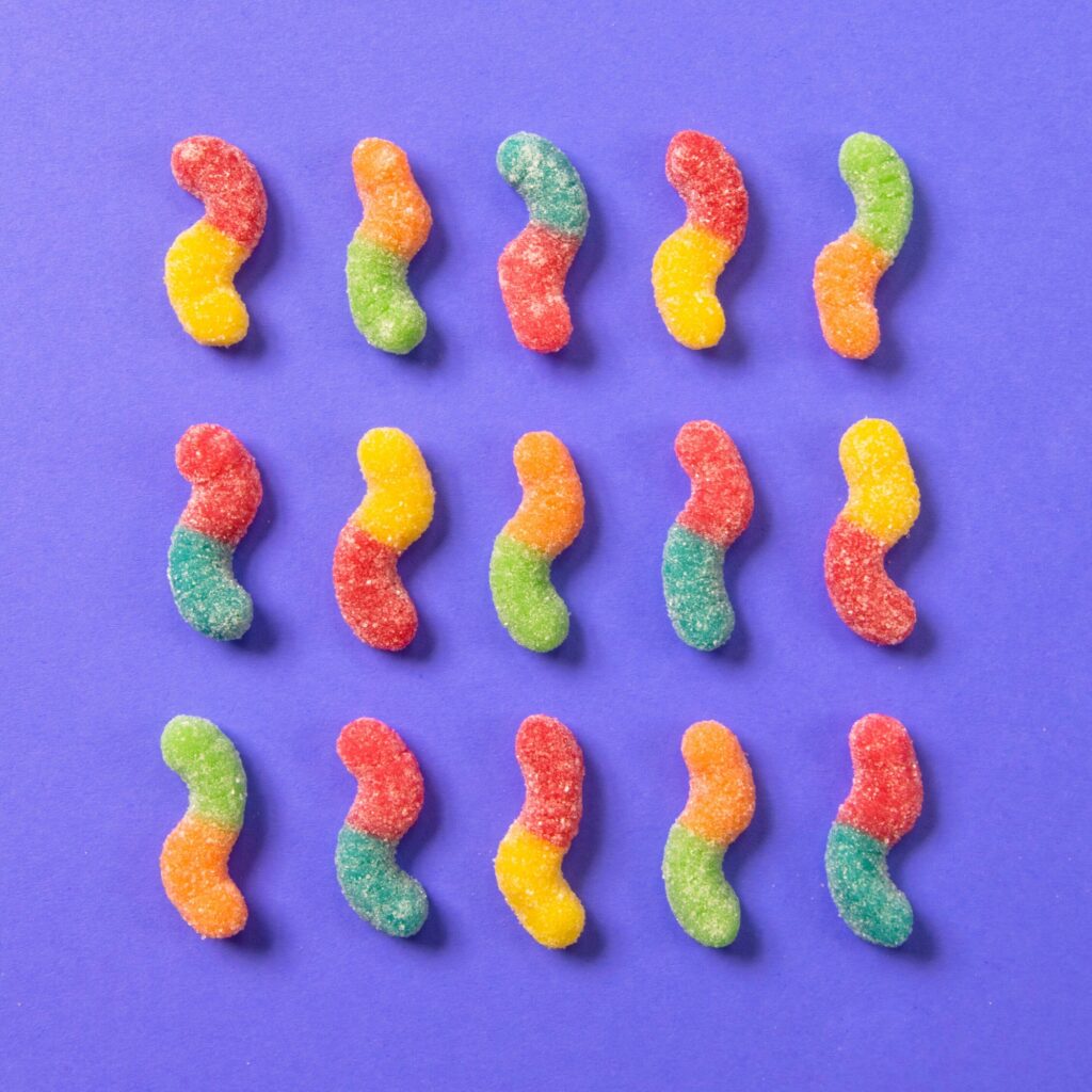 Orangized color candy gummy worms flat lay food